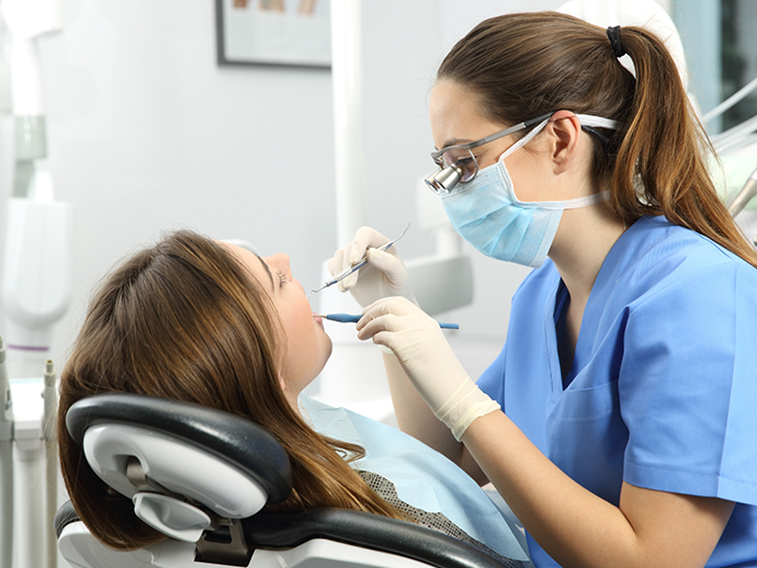 Dental hygienist giving a patient a teeth cleaning