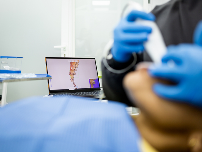 Dentist capturing digital impressions of a patients teeth