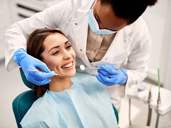 A smiling woman undergoing a dental checkup
