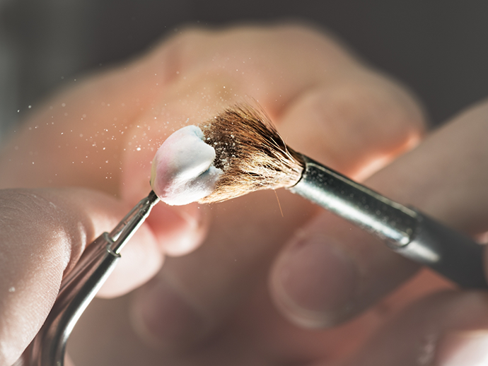 Close up of a dental crown being brushed