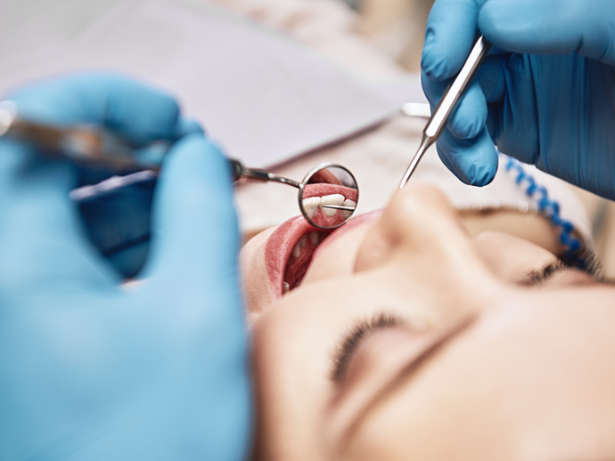 Close up of a dental patient receiving a preventive dentistry checkup