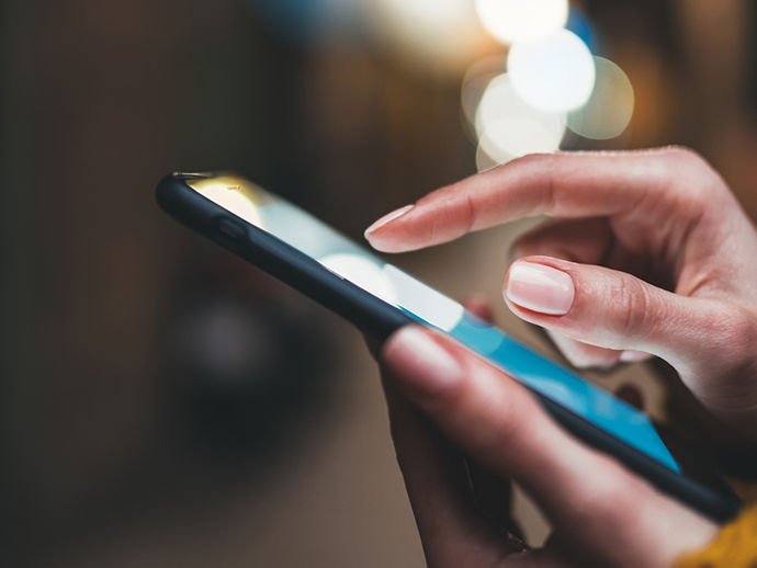 Close up of a person scrolling on their phone